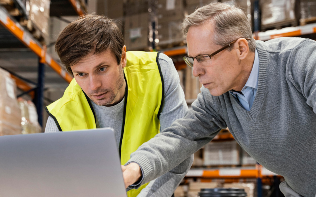 Manufacturing business owner shaking hands with a buyer, representing a successful sale and transition.